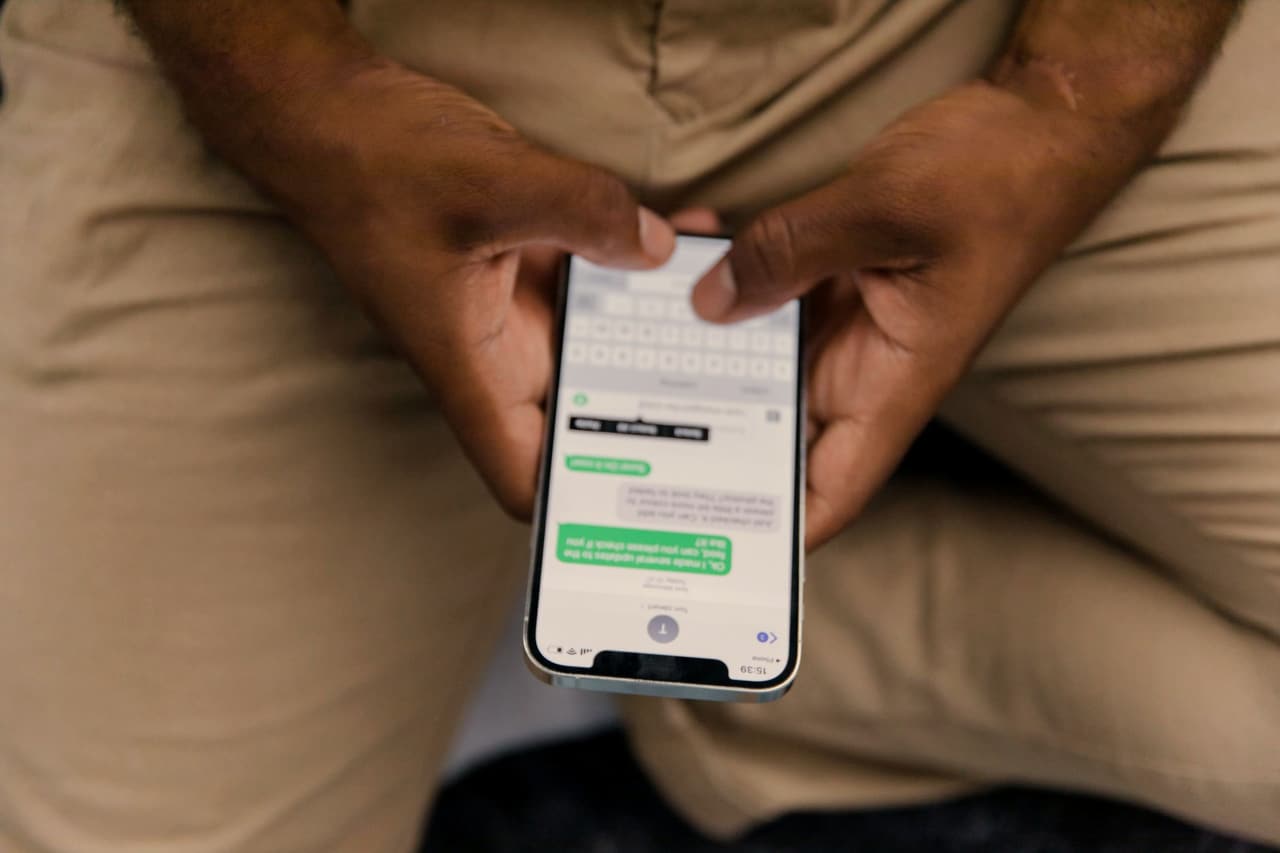 Hands holding a phone, reading a message